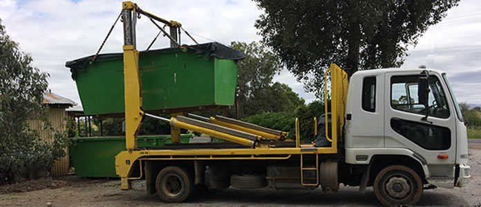 Skip Bins being loaded onto Truck