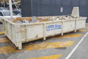 Hook Lift Bin services available in Sale for recycling heavy materials like bricks and rubble