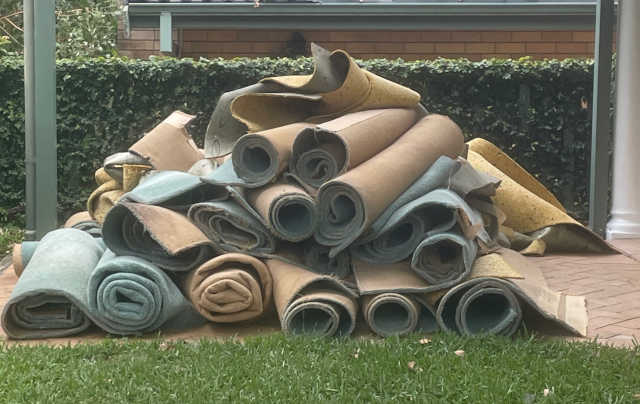 Rolls of Carpet ready for disposal