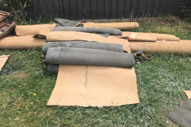 Rolls of wool Carpets on Lawn In Casey (where there are no commercial recycling facilities nearby)